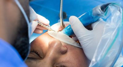 dentist and assistant with tool makes some manipulations in the patient's mouth